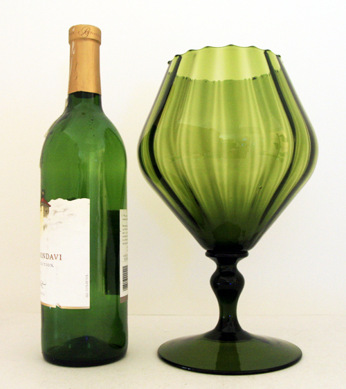 Hand-blown with applied stem and hand-tooled ruffled rim.