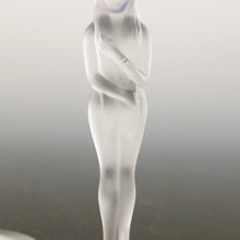 The frosted solid glass 'bashful' nude is covering most of her personal parts with her hands and hair.