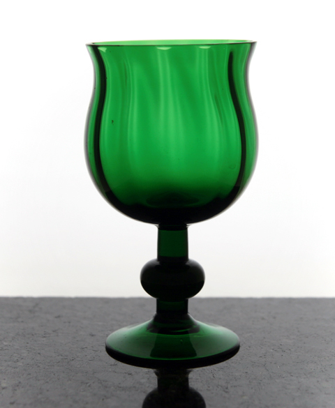 Blown emerald green baluster wine glass with optic decor.