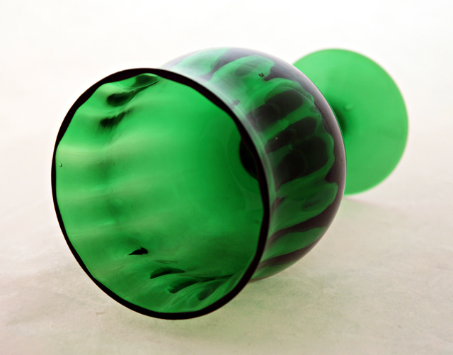 Optic molded glass on bowl is smooth on the exterior and ribbed on the interior.