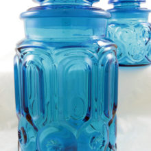 Pair of early Moon and Star pattern kitchen canisters. Made by LE Smith, circa 1930s - 1940s. The set includes a large gallon canister and a quarter gallon canister made with thick mold blown glass with pontil scars on seat (left by the makers tool).