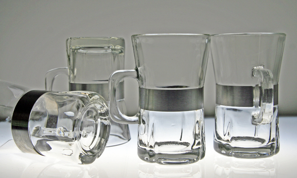 Set of 4 brushed steel banded hot beverage mugs.