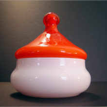 Wonderful Eames era circus tent jar with fire orange lid.