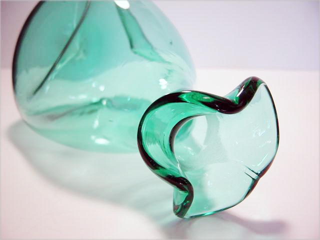 Hand blown with soft pontil marks.
