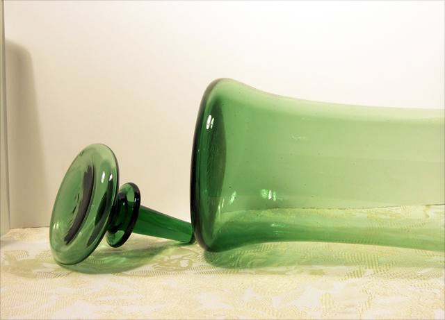 Hand blown, has a few bubble inclusions, expected. Blown stopper is hollow with a solid stem.