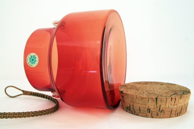 The cork top is hard with age but seals airtight and looks in amazingly good shape considering material and age. Handle survived in great shape too. This item wasn't used much. Jar has medium bottom wear.