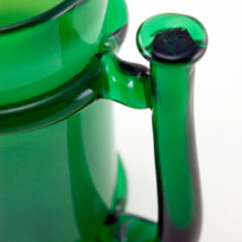 Stylized handle with thumb tab helps get a good grip for what would be a very heavy drink.