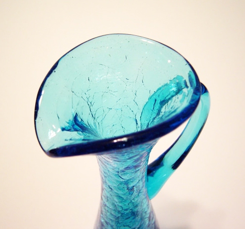 Hand blown into mold, fine crackled, hand-tooled spout and applied handle. No pontil mark or mold lines visible.