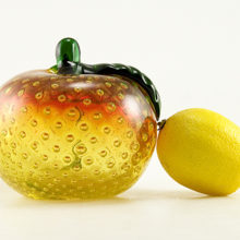 Stunning three pound ruby and uranium glass art peach figurine. This absolutely beautiful vintage sommerso glass peach with hand-blown quality glass. The peach is blown hollow with heavy, very thick walls. The ample emerald green stem and leaf were tooled separately and applied to the peach.
