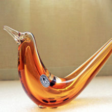 Hand-made with full-length stylized center bubble encased in amber glass, then encased with clear glass. Applied eyes and beak.