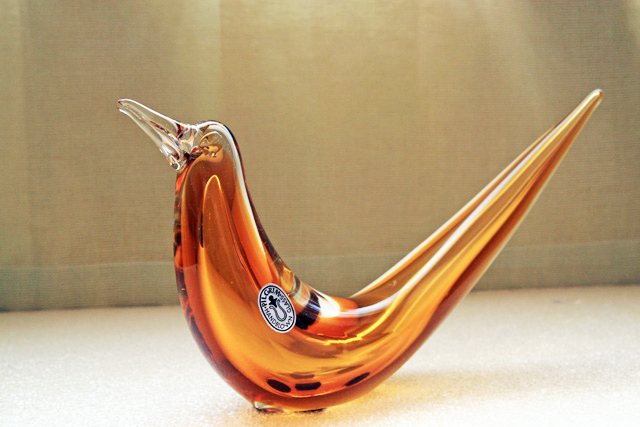 Hand-made with full-length stylized center bubble encased in amber glass, then encased with clear glass. Applied eyes and beak.
