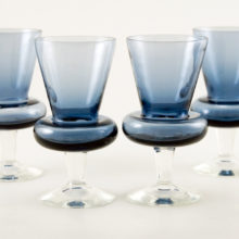 Set of four hand-blown steel blue crystal cocktail stems.