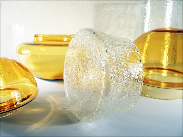 Hand blown amber glass mushroom caps on mold blown textured colorless glass stems.