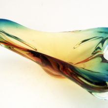 Hand-formed glass is peppered with tiny air bubbles and one inclusion, this is common on vintage blown glass.