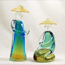 Set of two Italian Sommerso art glass Oriental figures in blue & yellow under clear glass with gold flecks in hats.