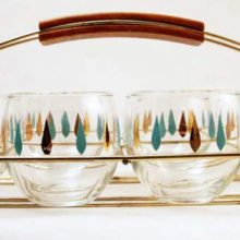 Wonderful complete set of 8 atomic era roly-poly tumblers with original rack.