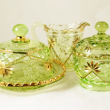 A lovely early 4 part mold gilded Vaseline glass table service set.