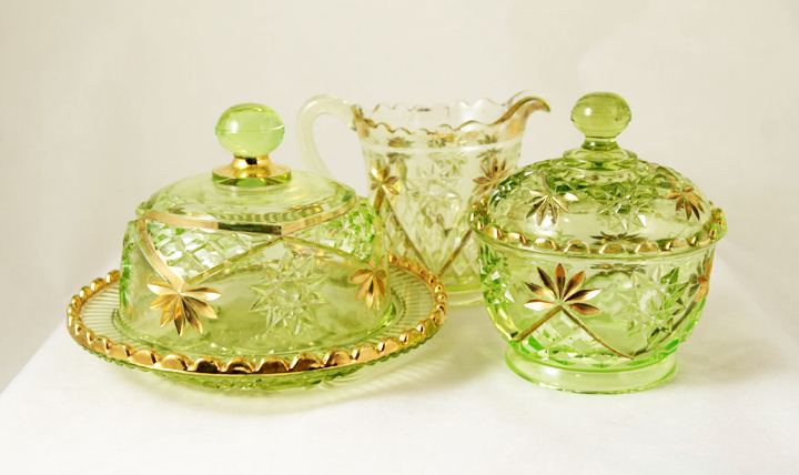 A lovely early 4 part mold gilded Vaseline glass table service set.