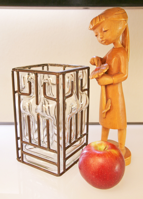 The caged glass style was popular in the late 1800's to early 1900's, most made in France by the likes of Daum-Nancy which were extreme high-end and usually in colorful glass.