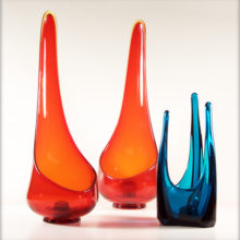 Using thick, lovely orange glass, these Taperglow candle vases were hand blown from a mold.