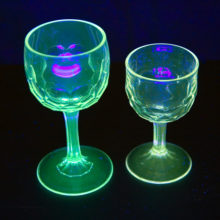 The larger goblet has a faint tint of purple, the smaller has not been effected by ultraviolet light and is colorless. Both have medium weight solid rings of bottom-wear. Both light-up under black-light, the smaller reflecting less intensely.