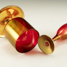 Beautiful gold ruby blown glass. The Ruby glows gold. The stems are enameled gold.