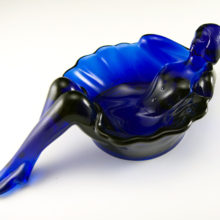 This lovely ballerina dish is a contemporary reproduction of an Art Deco era Westmoreland Glass design. It was made by Summit Art Glass, a modern glass importer which acquired Westmoreland molds.