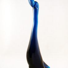 It's a big goose standing 13.5" Tall. Solid vintage quality glass weighs 2 lbs. Mesmerizing deep blue color lightens and darkens according to the thickness of the glass.