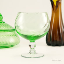Made in the 1940's - 1960's by Duncan Glass, U.S.A. a famous maker of elegant glassware. Measures 5.5" tall with a 3.5' wide mouth. Hand-blown from a swirl optic mold in a beautiful glowing green.