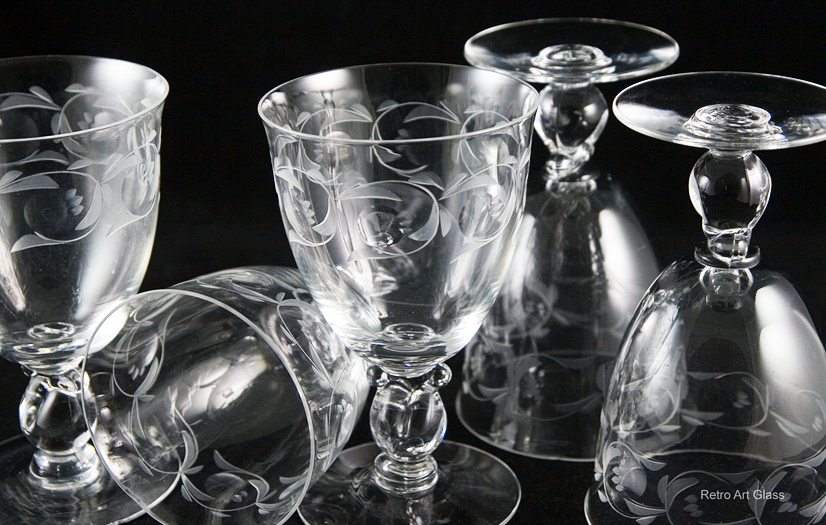 This Mid-century elegant crystal is from one of America's finest makers. These goblets are with the beautiful Heisey style, 'Lariat' No. 1540, designed by Horace King. The interesting shape of the solid crystal stem was originally called 'Gordian Knot'.