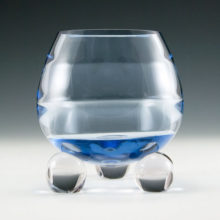 Vintage crystal ball vase with horizontal optic panels and three ball feet.
