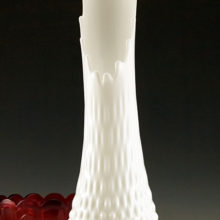 A tall, elegant mid-century vase with pure white opaque glass that accentuates any color scheme.