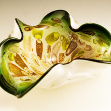This style of cane, murrine and metallic flecked decor is usually attributed to Dino Martens of Art Vetraris Muranese (A.VE.M). Murrine, also spelled Murrhine and Murrina, is a venetian style technique of imbedding colored cane sections into the glass before is is blown into a shape.