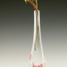 Hand blown crystal vase sits slightly off-center by design.