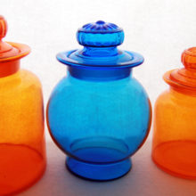 d finials with a stylized flower. Lids were blown into mold and hand finished. Vessels are hand blown, no mold lines, smooth swirled pontil marks. Medium weight glass. Imported and stocked at Gump's in San Francisco during the late 1960s to early 1970s. Made by Takahashi, a famous mid-century Japanese art glass and art pottery maker.