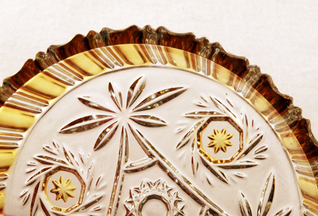 The golden yellow color is permanently stained on the glass (applied by hand) and fused by extreme heat. It will not wear off (as flashed glass can). This decor was sometimes called "Amberette".