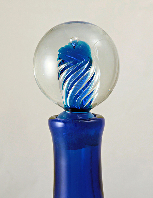 Stands 14.25" tall, 13" at widest with a widest circumference of 39". Weighs a total of 7 lbs, with the stopper weighing 1.5 lbs by itself.