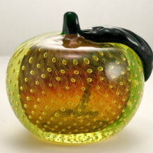 The Venetian glass peach is blown in sommerso (2 layers of glass blown together) with heavy, very thick walls. The ample emerald green stem and leaf were tooled separately and applied to the peach.