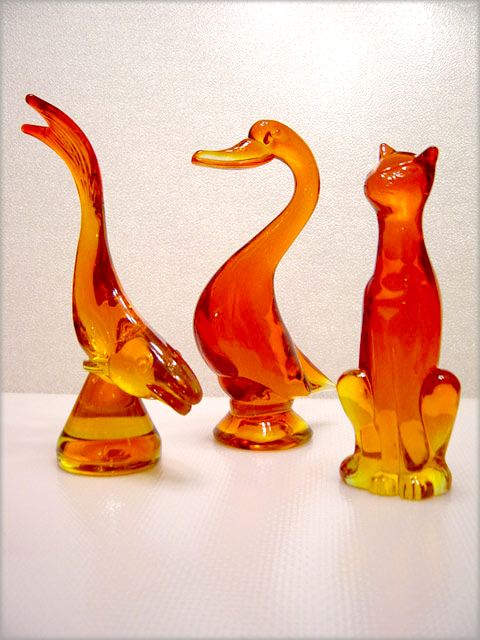 Viking Art Glass figurines, diving fish, sitting cat, and duck in persimmon.