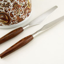 Nice hardwood handles with burlwood type grain on this Danish Modern Cutlery Set.