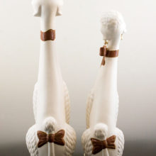 White male and female very tall ceramic poodles.