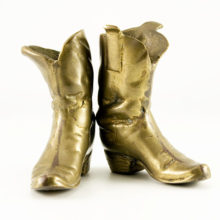 air of well-worn cowboy boots in solid brass.