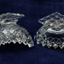 The diamond waffle cut of this crystal salt cellar set is deep and faceted and is on the base also.