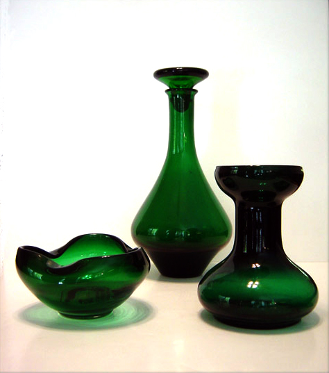 There are multiple uses for this green glass rose bowl: flowers, snacks, catch-all, candleholder.