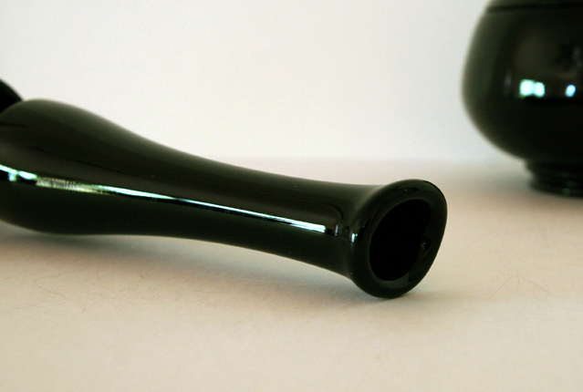The vase with the deco ebony wine stems was made by L.E. Smith or Fenton, blown from mold and swung to produce stylized neck and tip.