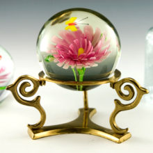 Beautiful large glass paperweight globe with encased glass flower and butterfly.