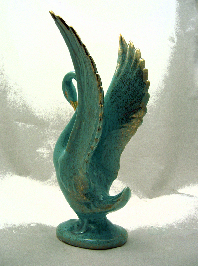 The finish of this pottery swan figurine is a beautiful turquoise w/ gold specks.