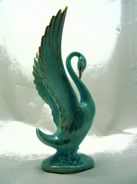 The pottery swan figurine measures 14" tall and 6.5" deep and 6.5" at widest.
