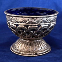 Mysterious hand-made Islamic pewter chalice encased with cobalt blue glass.