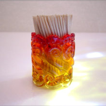 A beautiful little piece, this Amberina glass toothpick holder is made by Kanawha Art Glass.